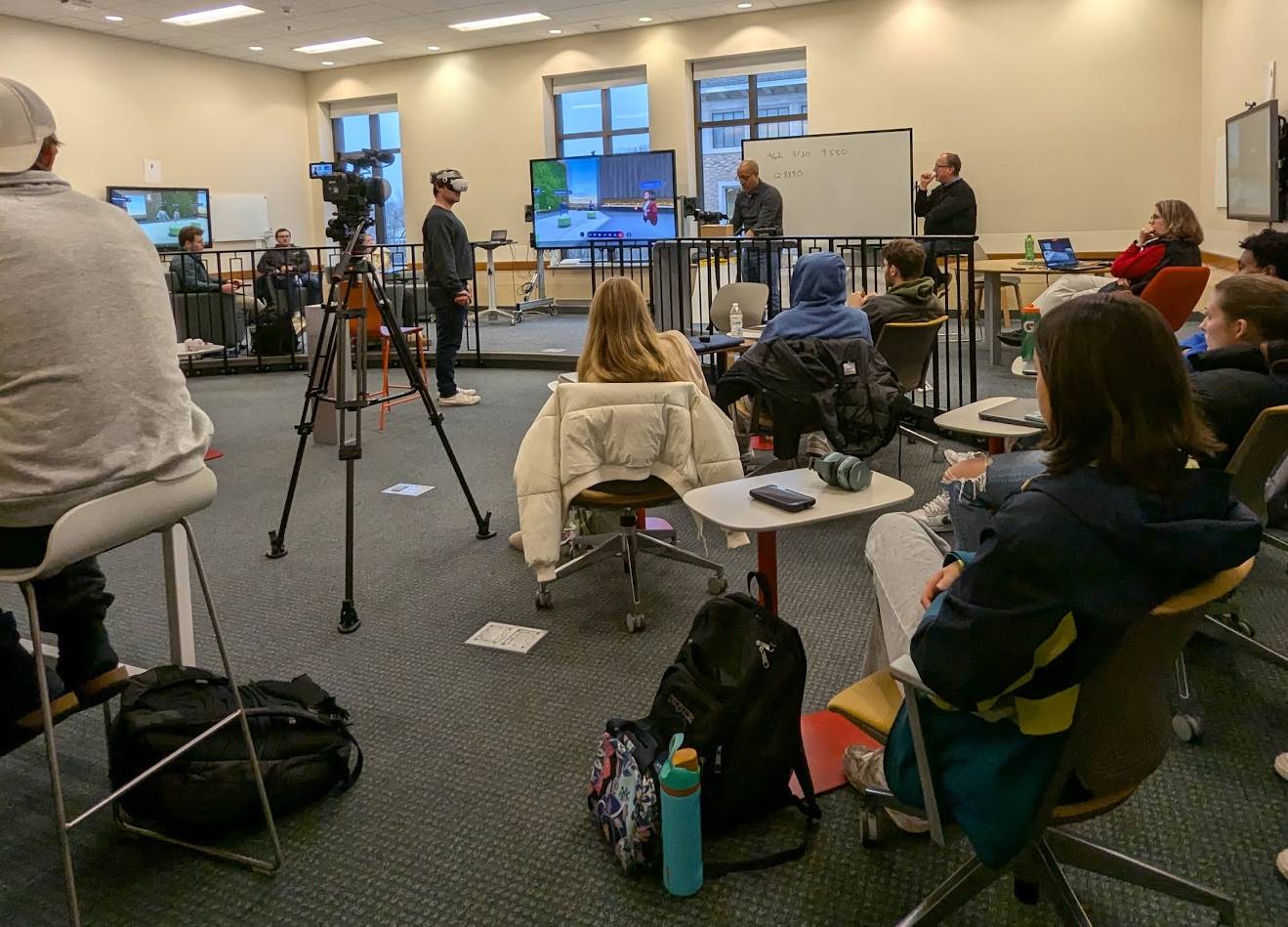 Student in a classroom is wearing a virtual reality headset.